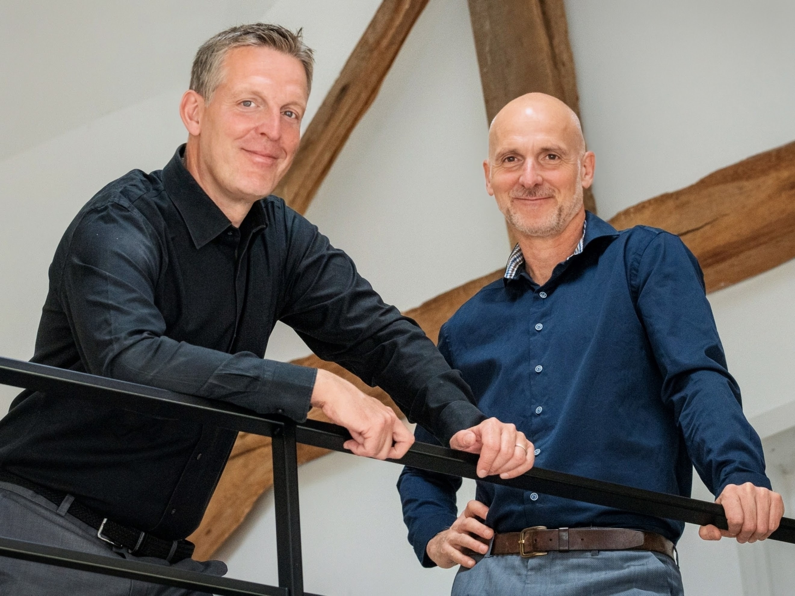 Photo of the founders, Bram and Eric, smiling and looking professional.